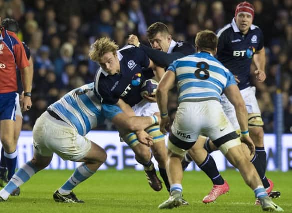 Scotland's Jonny Gray (centre) is tackled by Pablo Matera. Picture: SNS