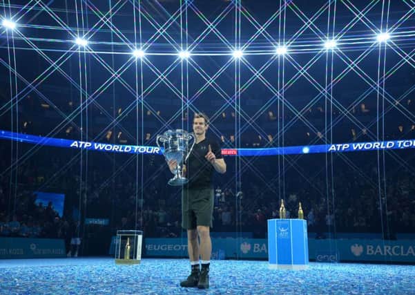 Andy Murray poses with the ATP World Number One trophy after winning the men's singles final against Serbia's Novak Djokovic. Picture: Glyn Kirk/AFP/Getty Images