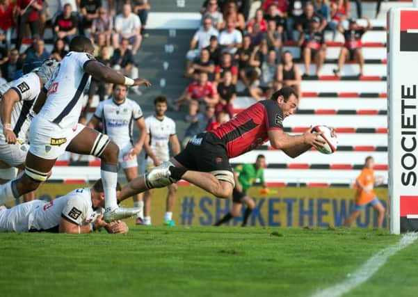 Georgia skipper Mamuka Gorgodze scores the winning try for Toulon after evading a tackle from Clermonts French hooker during a Top 14 match. The flanker is one of a number of Georgian internationals who play key roles for Top 14 clubs. Picture: Bertrand Langlois/AFP/Getty