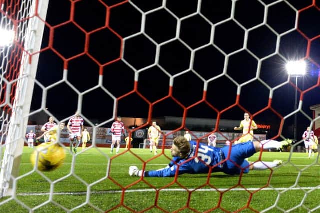 Hamilton goalkeeper Gary Woods fails to reach Jamie Walkers 73rd-minute penalty. Picture: Rob Casey/SNS