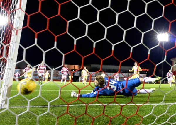 Hamilton goalkeeper Gary Woods fails to reach Jamie Walkers 73rd-minute penalty. Picture: Rob Casey/SNS