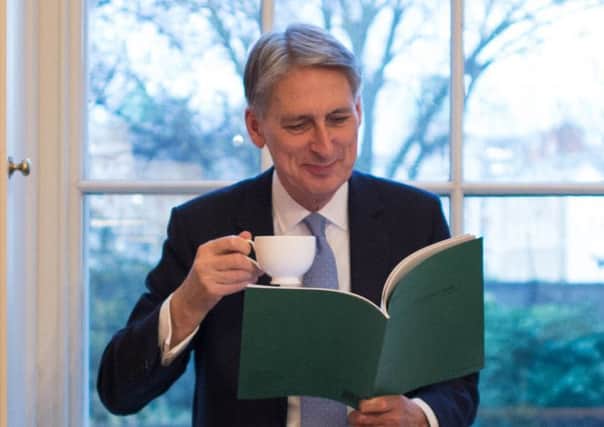 Philip Hammond has a look through his Autumn Statement yesterday before he goes public today. Picture: PA
