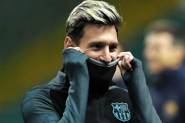 Lionel Messi, back in training after missing Saturdays draw with Malaga, is well wrapped up at Celtic Park. Picture: Andy Buchanan/AFP/Getty Images