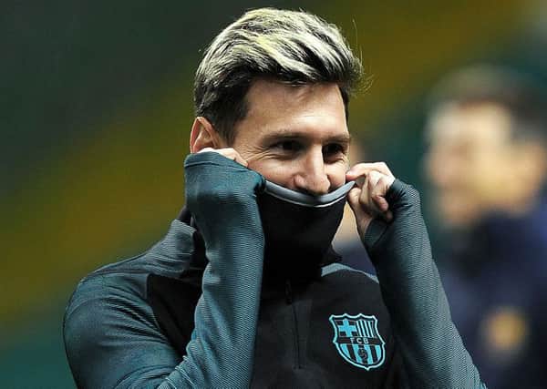 Lionel Messi, back in training after missing Saturdays draw with Malaga, is well wrapped up at Celtic Park. Picture: Andy Buchanan/AFP/Getty Images