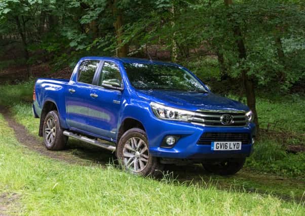 The Toyota Hilux drives better with a heavy load, though the console and chassis have been refined.