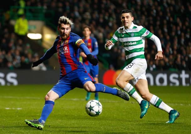 Tom Rogic looks on helplessly as Lionel Messi opens the scoring for Barcelona. Picture: PA