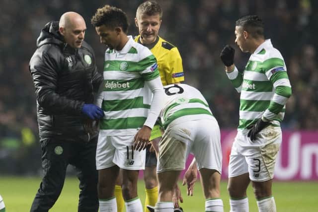 Scott Sinclair, second from the left, receives treatment after a foul from Jordi Alba. Picture: SNS