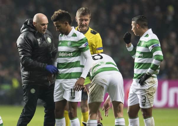Scott Sinclair, second from the left, receives treatment after a foul from Jordi Alba. Picture: SNS