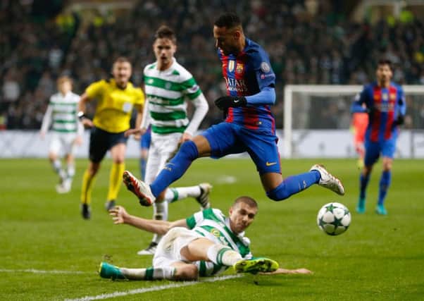 Barcelona's Neymar takes to the air to hurdle sliding Celtic defender Jozo Simunovic. Picture: Owen Humphreys/PA Wire