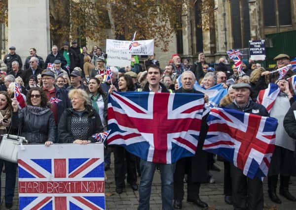 Pro-Brexit demonstrators hold Union Jack flags as they protest outside the Houses of Parliament. (Photo by Jack Taylor/Getty Images)
