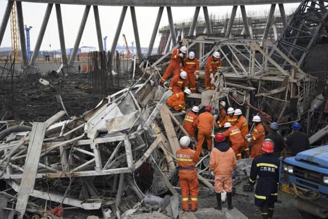 Rescue workers look for survivors after a work platform collapsed at the Fengcheng power plant in eastern Chinas Jiangxi Province. Picture: AP