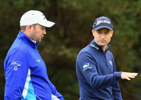 Duncan Stewart and Russell Knox chat ahead of the 2016 World Cup of Golf in Melbourne, Australia. Picture: Getty