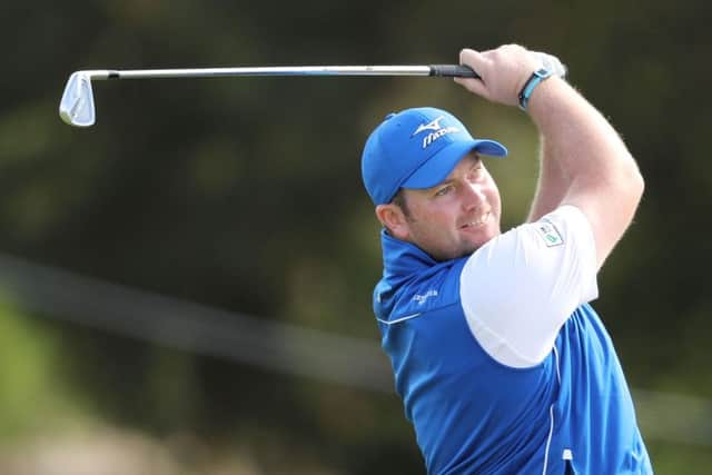 Duncan Stewart hits an approach during the opening round of the ISPS Handa World Cup of Golf in Melbourne. Picture: Getty Images