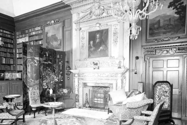 The impressive library at Newhailes House, complete with carved fireplace, seen here in 1938. The original interiors have largely been preserved. Picture: TSPL