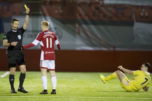 Ali Crawford is cautioned following a crude tackle on grounded Jamie Walker. Picture: SNS.