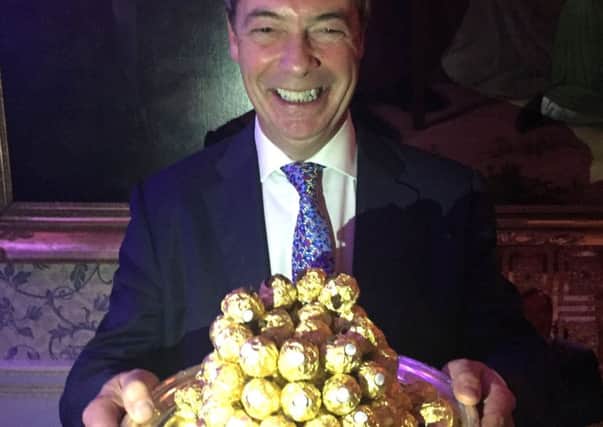 Nigel Farage offers round the ambassadorial  Ferrero Rocher chocolates at Ritz reception. Picture: PA