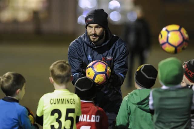 Kevin Thomson coaches kids at his new soccer school.
Picture: Neil Hanna