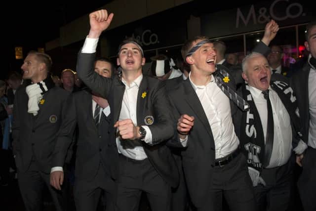 St Mirren celebrate their Scottish Communities League Cup victory with an open-top bus parade through Paisley. Kenny McLean, centre, and Jeroen Tesselaar lead the celebrations. Picture: SNS