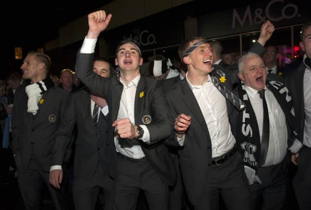 St Mirren celebrate their Scottish Communities League Cup victory with an open-top bus parade through Paisley. Kenny McLean, centre, and Jeroen Tesselaar lead the celebrations. Picture: SNS
