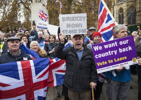 LONDON, ENGLAND - NOVEMBER 23: Pro-Brexit demonstrators protest outside the Houses of Parliament on November 23, 2016 in London, England. British Prime Minister Theresa May has said that she will not delay triggering article 50, the formal process of leaving the European Union, but wants to avoid a "cliff edge". (Photo by Jack Taylor/Getty Images)