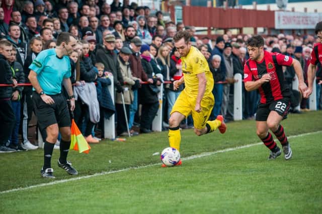 Bonnyrigg Rose's Lewis Turner vies with Dumbarton's Andy Stirling. Picture: Ian Georgeson