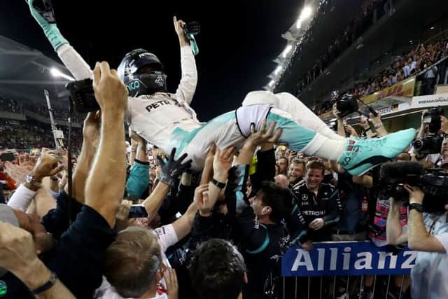 Nico Rosberg celebrates with his Mercedes team after finishing second and securing the Formula 1 title at the Abu Dhabi Grand Prix. Picture: Lars Baron/Getty Images