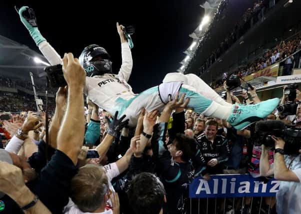 Nico Rosberg celebrates with his Mercedes team after finishing second and securing the Formula 1 title at the Abu Dhabi Grand Prix. Picture: Lars Baron/Getty Images