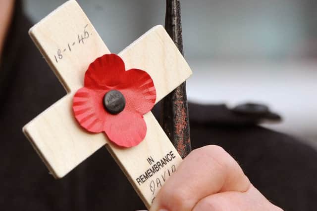Close up of a man holding a poppy tribute. 
 Picture: Ian Rutherford