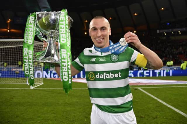 Scott Brown celebrates with the Betfred Cup trophy. Picture: SNS