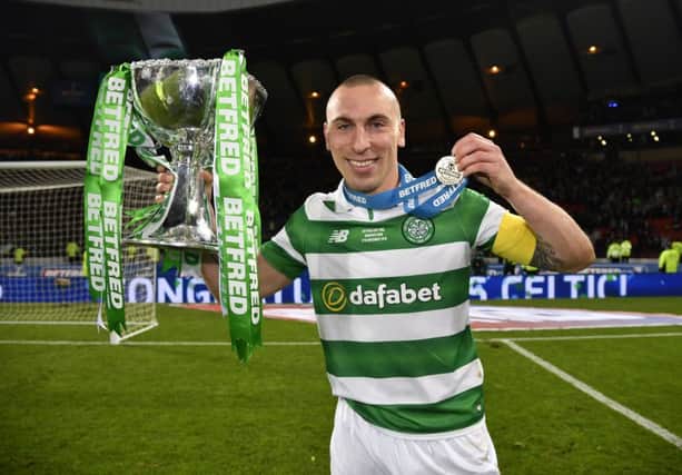 Scott Brown celebrates with the Betfred Cup trophy. Picture: SNS