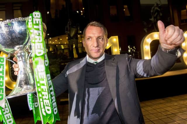 Brendan Rodgers holds aloft the Betfred Cup outside Celtic Park. Pic: SNS