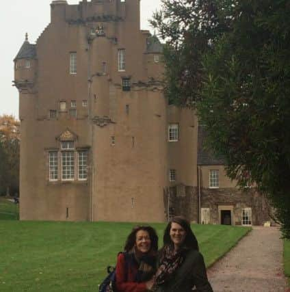 Bill Andrew captured an unexplained figure in the doorway in this photo of his daughter Coleen (centre), granddaughter Jessica and great-grandson Findley. Picture: Contributed