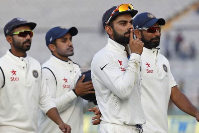 India captain Virat Kohli makes a 'shush' gesture to the dismissed Jonny Bairstow. Picture: Altaf Qadri/AP