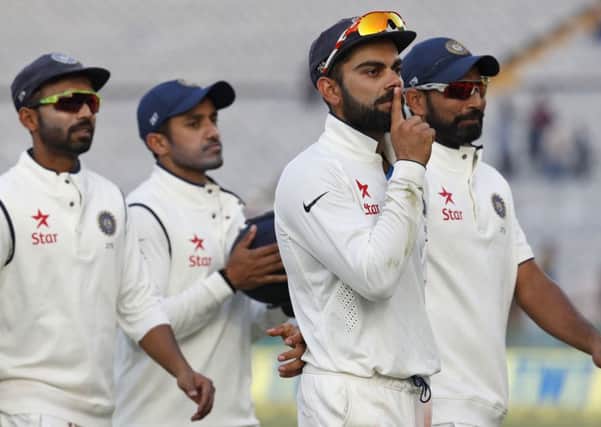 India captain Virat Kohli makes a 'shush' gesture to the dismissed Jonny Bairstow. Picture: Altaf Qadri/AP