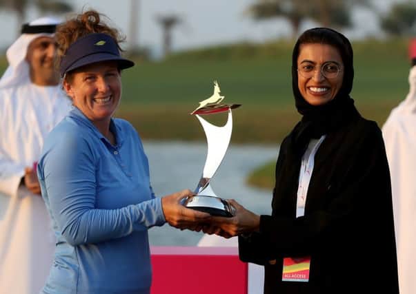 Beth Allen is presented with the  Fatima Bint Mubarak Ladies Open trophy by Her Excellency Noura Al Kaab, UAE Minister of State for Federal, and National Council Affairs. Picture: Francois Nel/Getty Images
