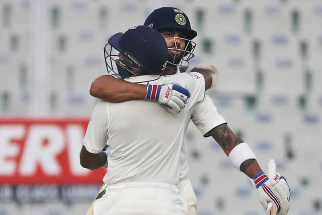 Captain Virat Kohli, right, and Parthiv Patel embrace each other as they celebrate India's win over England on the fourth day of the third Test in Mohali. Picture: AP Photo/Altaf Qadri