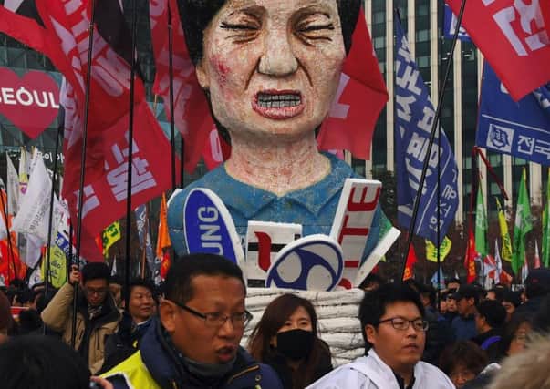 Protesters carry an effigy of South Koreas President Park Geun-Hye during an anti-government rally in Seoul. Picture: AFP/Getty Images