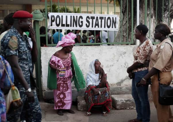 Gambians wait to cast their vote at a polling station in the capital, Banjul. Picture: AP