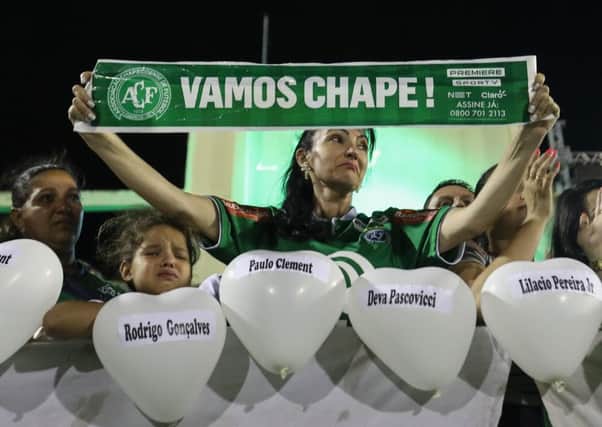 Fans cry while paying tribute to the players of Brazilian team Chapecoense Real at the club's Arena Conda stadium. Picture: Getty Images