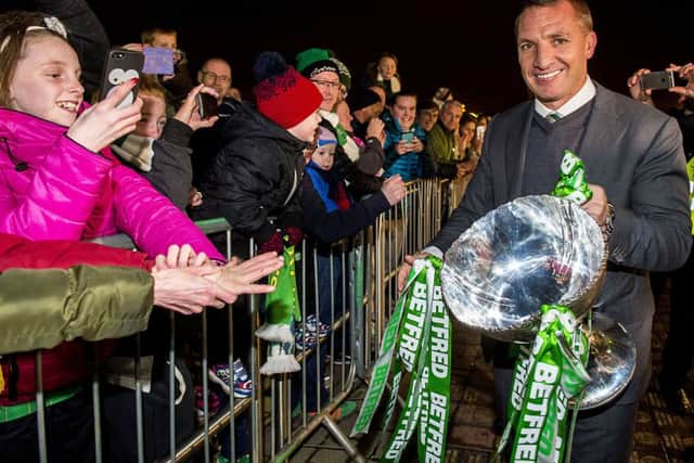 Celtic manager Brendan Rodgers shows fans the Betfred Cup. Picture: Bill Murray/SNS