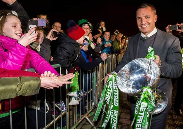 Celtic manager Brendan Rodgers shows fans the Betfred Cup. Picture: Bill Murray/SNS