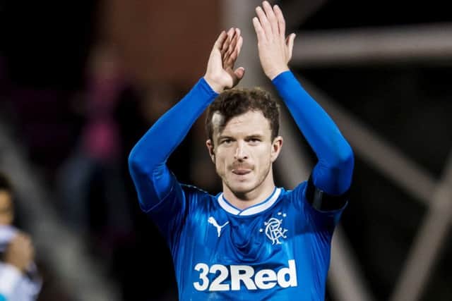 A grim-faced Andy Halliday applauds the Rangers fans following defeat at Tynecastle. Picture: SNS.