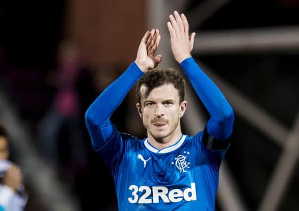 A grim-faced Andy Halliday applauds the Rangers fans following defeat at Tynecastle. Picture: SNS.