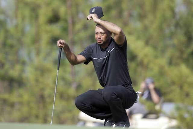 Tiger Woods wipes his face as he prepares to putt on the tenth hole during the first round at the Hero World Challenge in Nassau, Bahamas. Picture: AP/Lynne Sladky