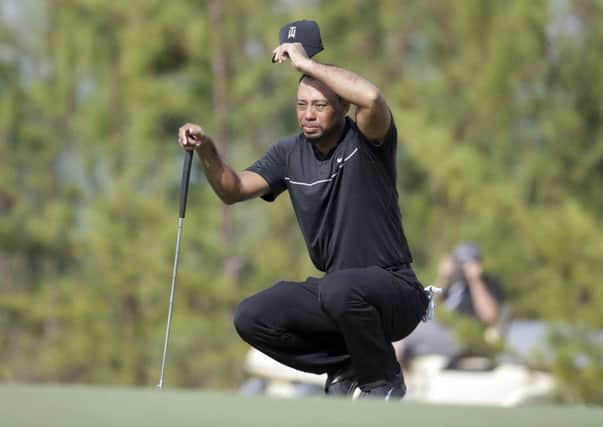 Tiger Woods wipes his face as he prepares to putt on the tenth hole during the first round at the Hero World Challenge in Nassau, Bahamas. Picture: AP/Lynne Sladky