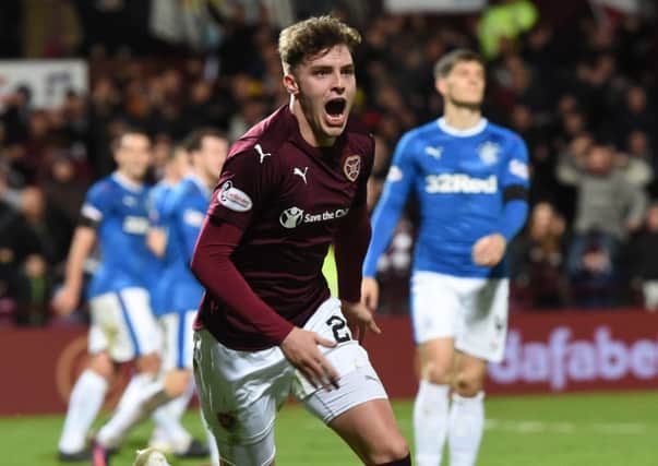 Robbie Muirhead celebrates with after putting Hearts 1-0 ahead. Picture: SNS