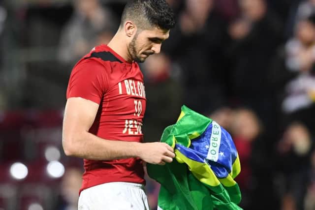 Hearts' Igor Rossi holding the Brazilian flag. Picture: SNS