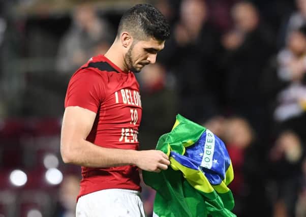 Hearts' Igor Rossi holding the Brazilian flag. Picture: SNS