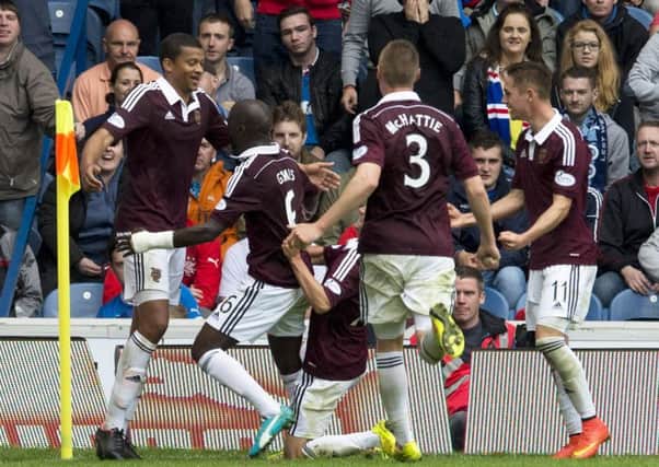 Osmain Sow, left, celebrates with team-mates after scoring the winner at Ibrox in 2014. Picture: SNS.