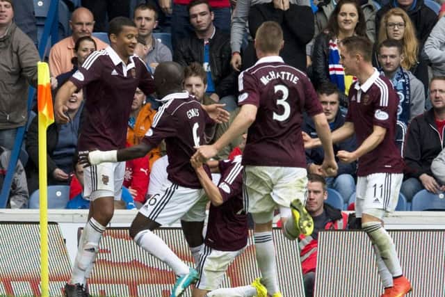 Osmain Sow, left, celebrates with team-mates after scoring the winner at Ibrox in 2014. Picture: SNS.